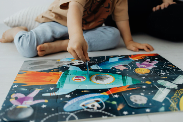 An image of child solving puzzle for brain development.