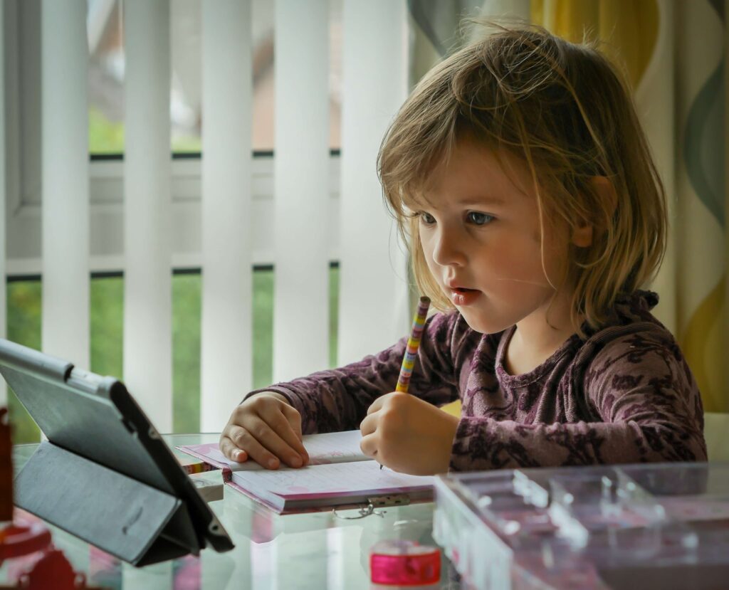 An image of a child using tablet for home work.