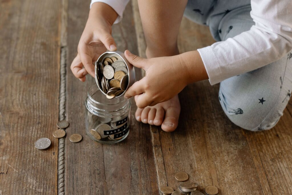 An image of a child volunteering his pocket money. It is one of the things to do with kids.