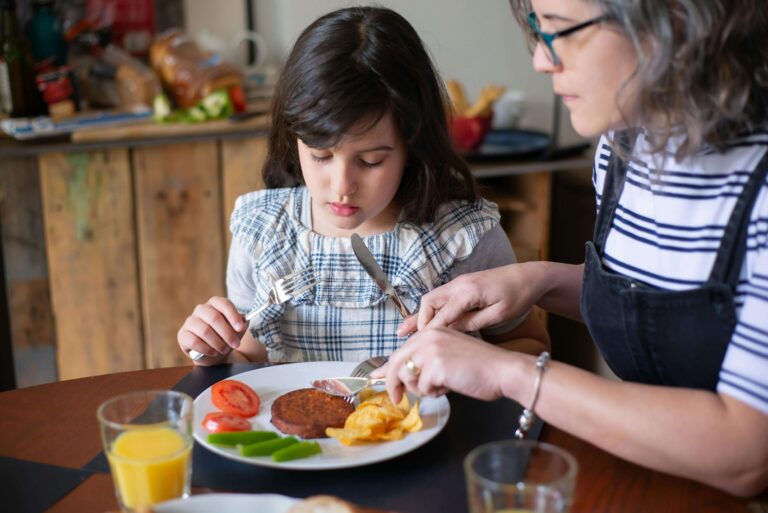 An image of a toddler learning table manners.