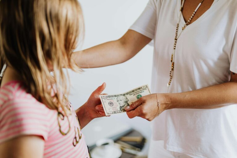 An image of an elder giving money to a child that he earn money.