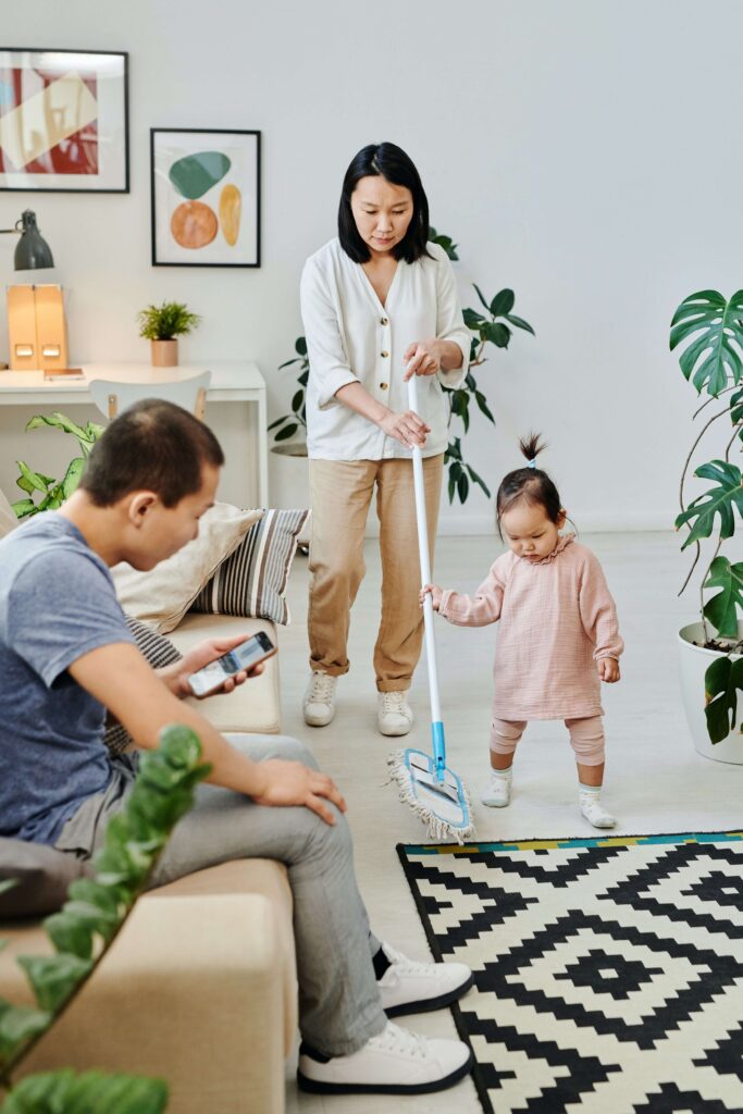 An image of a family cleaning the house and get kids to listen to instructions.