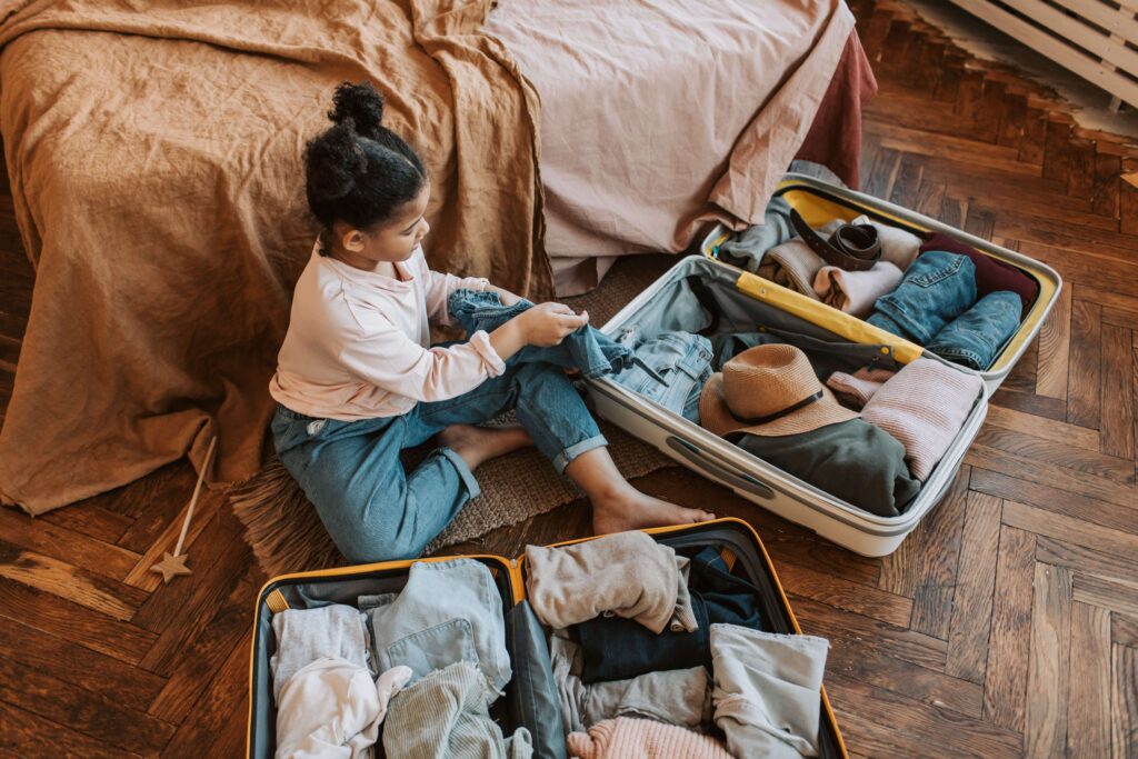 An image of child packing for traveling.
