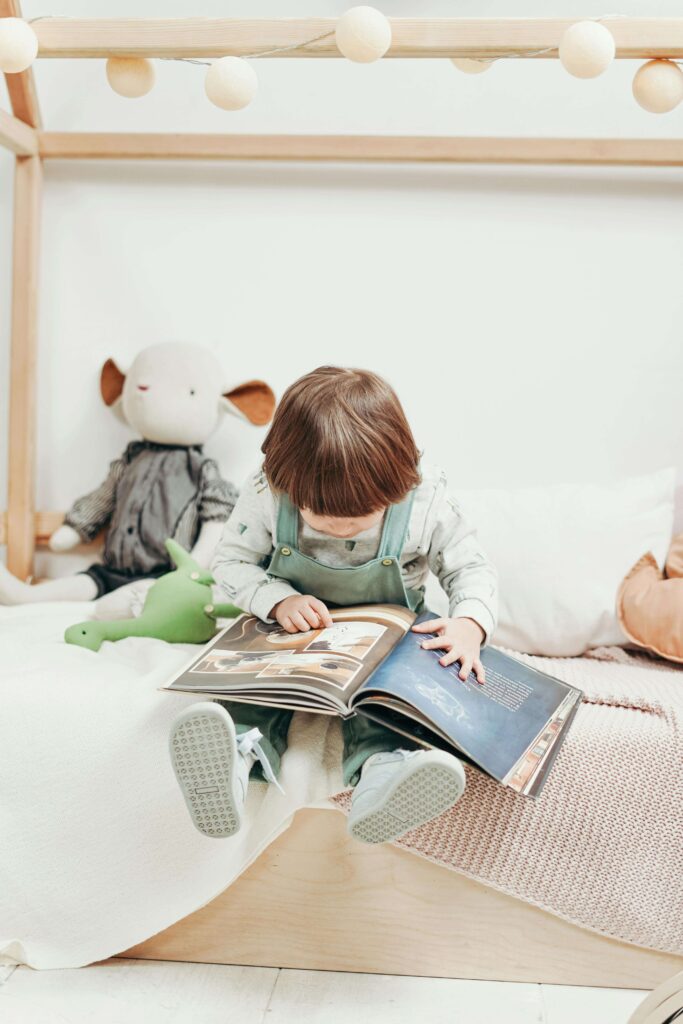 An image of a child reading book because books reading is best for early childhood education.
