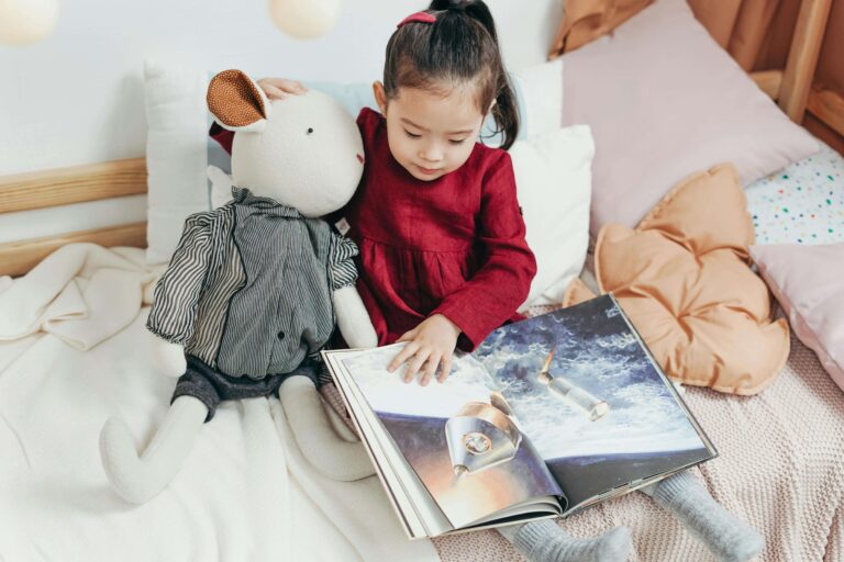 An image of a toddler reading books because it is better for early childhood education.