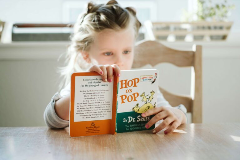 An image of a child reading a book. As it is a brain development activity for children according to the neuroscience.