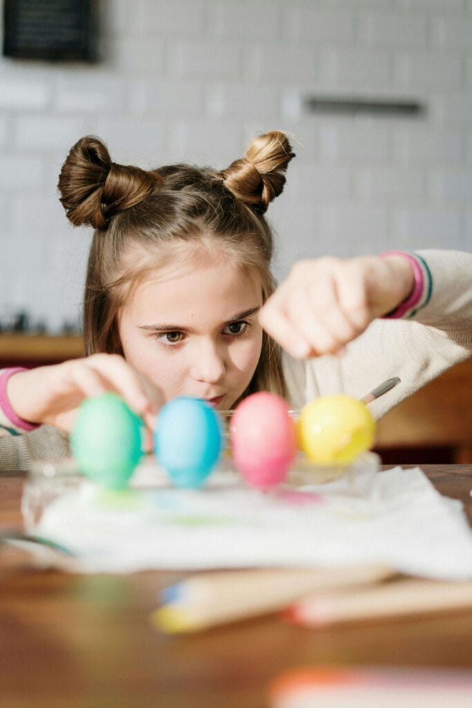 An image of a strong-willed child who is keenly experimenting with eggs.