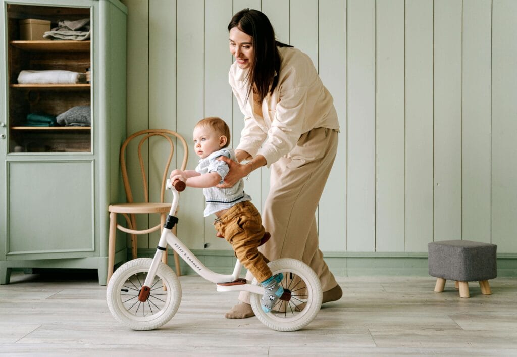 An image of a strong-willed child who is trying to learn riding bicycle.